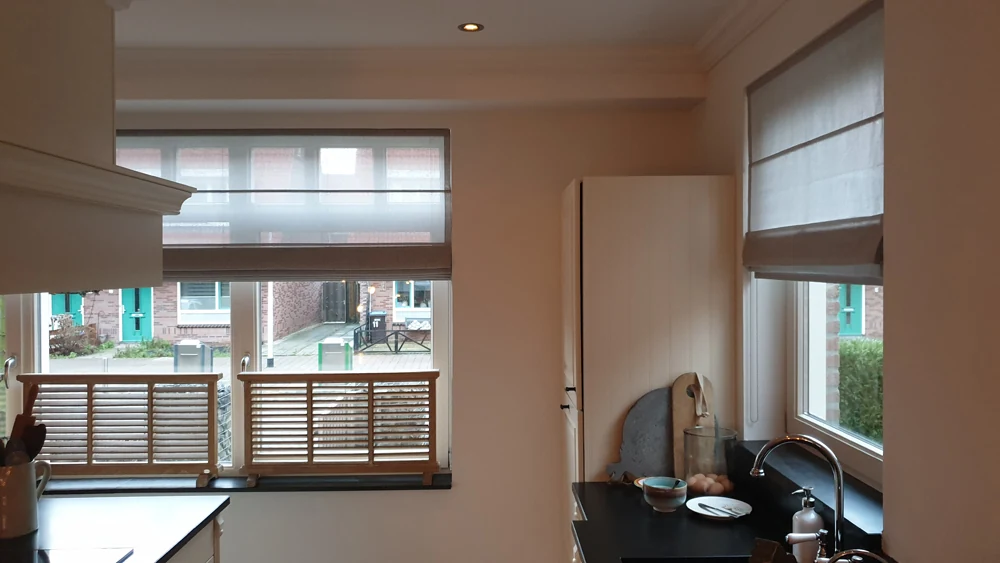 Project met taupe vouwgordijnen in een keuken